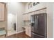 Kitchen with stainless steel refrigerator, pantry, light wood cabinets, and desk at 8170 Sw 56Th Avenue Rd, Ocala, FL 34476