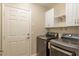 Laundry room features a door leading outside, shelving, washer and dryer at 8170 Sw 56Th Avenue Rd, Ocala, FL 34476