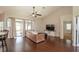 Spacious living room with vaulted ceiling, wood floors, and sliding glass doors at 8170 Sw 56Th Avenue Rd, Ocala, FL 34476