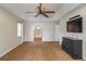 Carpeted main bedroom featuring a ceiling fan, a TV, and an arched doorway at 8170 Sw 56Th Avenue Rd, Ocala, FL 34476