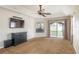 Carpeted main bedroom with ceiling fan, TV, windows, and glass door to the outside at 8170 Sw 56Th Avenue Rd, Ocala, FL 34476