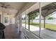 Wide, tiled patio features ceiling fans and screens, leading to a gazebo and fenced yard at 8170 Sw 56Th Avenue Rd, Ocala, FL 34476