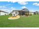 Beautiful backyard featuring a screened lanai, lovely landscaping, and an inviting seating area at 8606 Sw 61St Loop, Ocala, FL 34481
