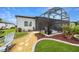 A view of the backyard, highlighting the screened lanai and decorative landscaping at 8606 Sw 61St Loop, Ocala, FL 34481