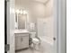 Clean, well-lit bathroom with a gray vanity, shower-tub combo, and neutral flooring at 8606 Sw 61St Loop, Ocala, FL 34481