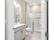 Modern bathroom with a glass enclosed shower, gray vanity, and neutral tile flooring at 8606 Sw 61St Loop, Ocala, FL 34481