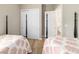 Bright bedroom with two twin beds, coral bedding, and ensuite bathroom access at 8606 Sw 61St Loop, Ocala, FL 34481