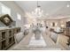 Dining room with decorative chandelier overlooking the kitchen and living areas at 8606 Sw 61St Loop, Ocala, FL 34481