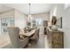 Dining room with a chandelier and view of the lush outdoors at 8606 Sw 61St Loop, Ocala, FL 34481