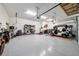 Roomy garage with ample lighting, coated flooring, and an abundance of storage options at 8606 Sw 61St Loop, Ocala, FL 34481