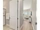 Hallway view leads to the main bedroom, featuring an ensuite bathroom and sunny windows at 8606 Sw 61St Loop, Ocala, FL 34481