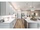 Modern kitchen boasts white cabinets, stainless appliances, subway tile backsplash, and wood floors at 8606 Sw 61St Loop, Ocala, FL 34481