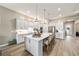 Bright kitchen features white cabinets, stainless steel appliances, and a large island with seating at 8606 Sw 61St Loop, Ocala, FL 34481
