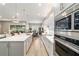Modern kitchen flows into dining & outdoor living space with stainless appliances and bright white cabinets at 8606 Sw 61St Loop, Ocala, FL 34481