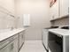 A bright laundry room with sleek cabinetry, modern washer and dryer, and ample counter space at 8606 Sw 61St Loop, Ocala, FL 34481