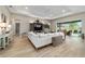 Spacious living room with tray ceiling and sliding glass doors to the outdoor space at 8606 Sw 61St Loop, Ocala, FL 34481