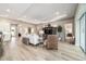 Bright open-concept living room boasts tray ceilings and wood-look tile at 8606 Sw 61St Loop, Ocala, FL 34481