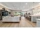 Open-concept living space with wood floors, dining area, and kitchen with breakfast bar at 8606 Sw 61St Loop, Ocala, FL 34481