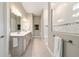 This main bathroom features double sinks, vanity, and a frameless shower with white tiling and a linear accent at 8606 Sw 61St Loop, Ocala, FL 34481