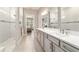 Bright main bathroom with double sinks, white countertops, and a frameless shower, adjoining the main bedroom at 8606 Sw 61St Loop, Ocala, FL 34481