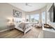 Bright main bedroom featuring hardwood floors, large windows, neutral walls, and coastal decor at 8606 Sw 61St Loop, Ocala, FL 34481