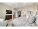 A spacious main bedroom is complete with a four-poster bed, dresser with TV, ensuite and seating at 8606 Sw 61St Loop, Ocala, FL 34481