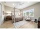 Calm main bedroom with four-poster bed, neutral decor, wood floors and plantation shutters at 8606 Sw 61St Loop, Ocala, FL 34481