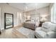 Inviting main bedroom with four-poster bed, wood floors, and ensuite bathroom access at 8606 Sw 61St Loop, Ocala, FL 34481