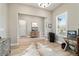 Stylish home office with a cowhide rug, workstation, and bright window light at 8606 Sw 61St Loop, Ocala, FL 34481