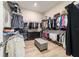 Organized walk-in closet with shelving, hanging racks, a dresser, and a central ottoman at 8606 Sw 61St Loop, Ocala, FL 34481