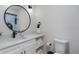 Clean bathroom featuring a modern vanity, large mirror, and fresh white towels at 8622 Baylor Cir, Orlando, FL 32817