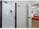 Modern bathroom with white tiled shower and glass door leading to the bedroom at 8622 Baylor Cir, Orlando, FL 32817