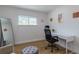 Cozy bedroom with a minimalist design featuring a desk, chair, mirror, and ample natural light at 8622 Baylor Cir, Orlando, FL 32817