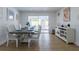 Bright dining room with modern table, chairs, console, and sliding glass doors at 8622 Baylor Cir, Orlando, FL 32817