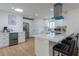 Bright kitchen with white cabinets, stainless steel appliances, quartz countertops, and island seating at 8622 Baylor Cir, Orlando, FL 32817