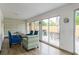Bright sunroom with comfortable seating, decorative wallpaper, and access to the backyard at 8622 Baylor Cir, Orlando, FL 32817