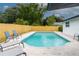 Inviting backyard pool featuring brick pavers, lounge chairs, privacy fence, and lush landscaping, ideal for relaxation and entertaining at 8622 Baylor Cir, Orlando, FL 32817