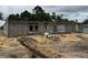 Exterior of home under construction with concrete blocks and sand, showing framing for window and door openings at 8664 Se 162Nd St, Summerfield, FL 34491