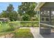 View of the screened-in lanai with a fenced yard and landscaping at 8784 Sw 93Rd Ln # A, Ocala, FL 34481