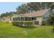 Backyard view highlighting the screened lanai and spacious lawn at 8784 Sw 93Rd Ln # A, Ocala, FL 34481