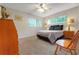 Bedroom featuring carpet, a ceiling fan, and natural light from two large windows at 8784 Sw 93Rd Ln # A, Ocala, FL 34481