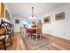 Traditional dining room with wood floors, a floral rug, and a decorative chandelier at 8784 Sw 93Rd Ln # A, Ocala, FL 34481