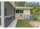 Exterior view of the home with a screened lanai and well-maintained landscaping at 8784 Sw 93Rd Ln # A, Ocala, FL 34481