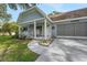 Quaint single-story home with a charming covered porch, attached garage, and landscaped front yard at 8784 Sw 93Rd Ln # A, Ocala, FL 34481