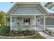 Inviting front porch with seating and a white picket fence, offering a cozy outdoor space at 8784 Sw 93Rd Ln # A, Ocala, FL 34481