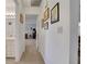 Hallway with neutral carpet, artwork, and access to bathroom and bedrooms for easy navigation at 8784 Sw 93Rd Ln # A, Ocala, FL 34481