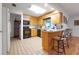 Kitchen featuring light wood cabinets, black appliances, and tile flooring at 8784 Sw 93Rd Ln # A, Ocala, FL 34481