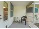 Covered patio area with a small table and chairs, creating a cozy outdoor space at 8784 Sw 93Rd Ln # A, Ocala, FL 34481