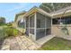 Enclosed screened-in lanai offering a private outdoor seating area with pavers and partial fencing at 8784 Sw 93Rd Ln # A, Ocala, FL 34481