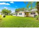 Expansive backyard featuring lush green grass and a glimpse of neighboring homes at 8874 Sw 95Th St # E, Ocala, FL 34481